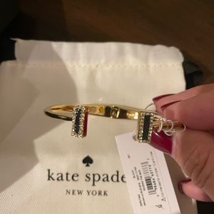 New, with tags, gold bracelet with navy and “diamond” stones.